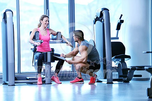 Gym woman exercising with her personal trainer Gym woman exercising with her personal trainer