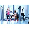 Gym woman exercising with her personal trainer