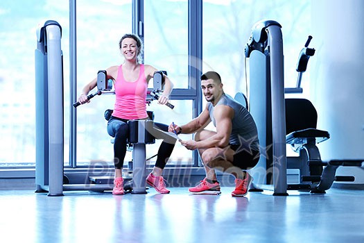 Gym woman exercising with her personal trainer Gym woman exercising with her personal trainer