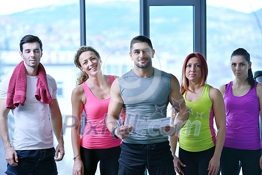 Group of people exercising at the gym and stretching Group of people exercising at the gym and stretching