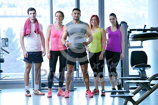 Group of people exercising at the gym and stretching Group of people exercising at the gym and stretching