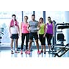 Group of people exercising at the gym and stretching