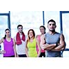 Group of people exercising at the gym and stretching