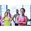 Group of people exercising at the gym and stretching