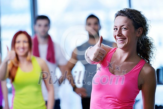 Group of people exercising at the gym and stretching