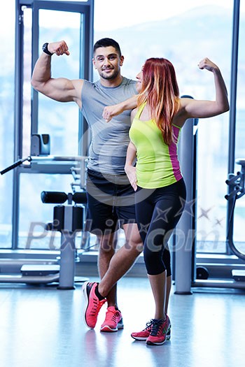 attractive couple at the gym looking happy attractive couple at the gym looking happy