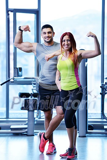 attractive couple at the gym looking happy attractive couple at the gym looking happy