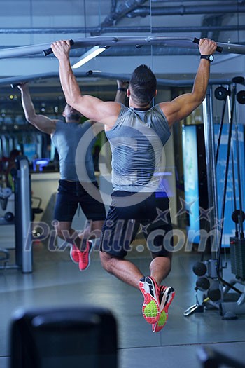 Strong handsome man exercising at the gym Strong handsome man exercising at the gym