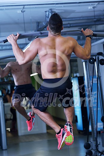 Strong handsome man exercising at the gym Strong handsome man exercising at the gym