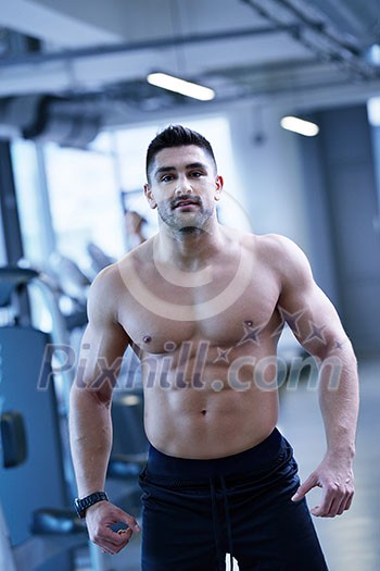 Strong handsome man exercising at the gym Strong handsome man exercising at the gym