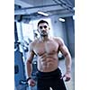 Strong handsome man exercising at the gym