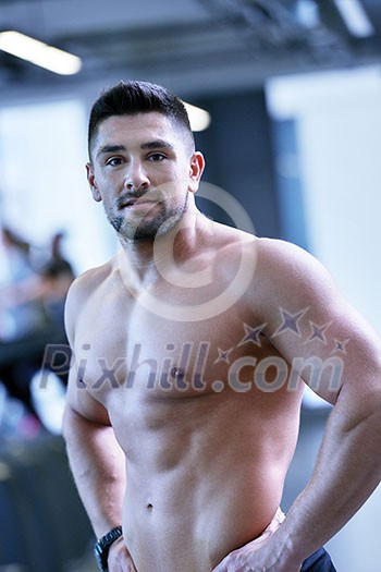 Strong handsome man exercising at the gym Strong handsome man exercising at the gym