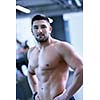 Strong handsome man exercising at the gym