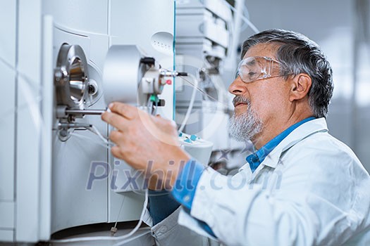 Senior male researcher carrying out scientific research in a lab (shallow DOF; color toned image) Senior male researcher carrying out scientific research in a lab (shallow DOF; color toned image)