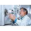 Senior male researcher carrying out scientific research in a lab (shallow DOF; color toned image)