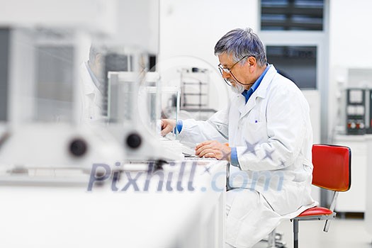 Senior male researcher carrying out scientific research in a lab (shallow DOF; color toned image) Senior male researcher carrying out scientific research in a lab (shallow DOF; color toned image)