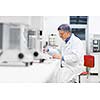 Senior male researcher carrying out scientific research in a lab (shallow DOF; color toned image)