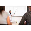 Senior chemistry professor giving a lecture in front of classroom full of students (shallow DOF; color toned image)