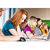 Students in a classroom during class (color toned image; shallow DOF)