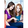 Young college students using a tablet computer in class (color toned image)