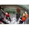 At the university/college - Students rushing up and down a busy stairway - confident pretty young female student looking upwards (color toned image)