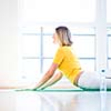 Pretty young woman doing YOGA exercise at home