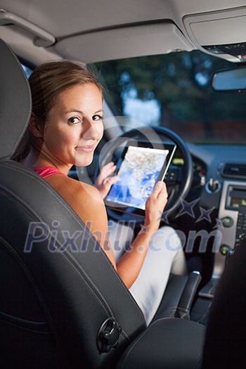 Pretty, female driver using her tablet computer (shallow DOF; color toned image) Pretty, female driver using her tablet computer (shallow DOF; color toned image)