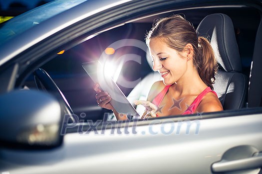 Pretty, female driver using her tablet computer (shallow DOF; color toned image) Pretty, female driver using her tablet computer (shallow DOF; color toned image)