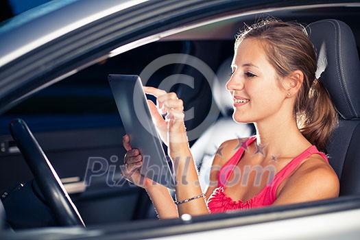 Pretty, female driver using her tablet computer (shallow DOF; color toned image) Pretty, female driver using her tablet computer (shallow DOF; color toned image)