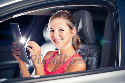 Pretty, female driver using her tablet computer (shallow DOF; color toned image) Pretty, female driver using her tablet computer (shallow DOF; color toned image)