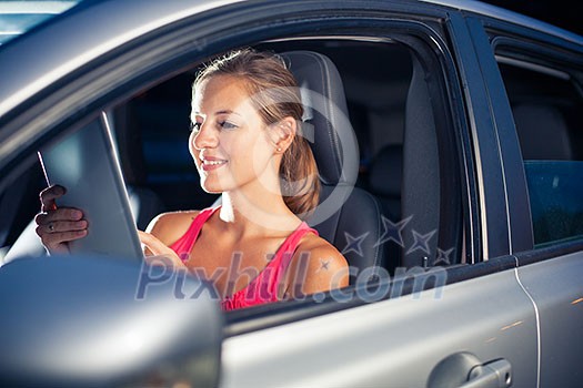 Pretty, female driver using her tablet computer (shallow DOF; color toned image) Pretty, female driver using her tablet computer (shallow DOF; color toned image)