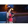 Pretty, female driver using her tablet computer (shallow DOF; color toned image)