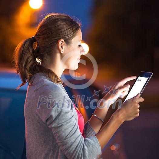 Pretty, female driver using her tablet computer (shallow DOF; color toned image) Pretty, female driver using her tablet computer (shallow DOF; color toned image)