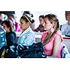 College students sitting in a classroom during class (shallow DOF; color toned image)