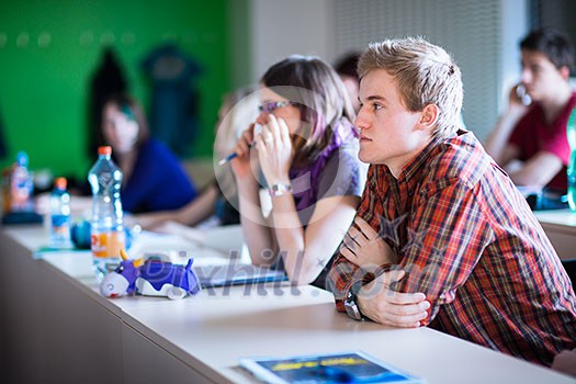 College students sitting in a classroom during class (shallow DOF; color toned image) College students sitting in a classroom during class (shallow DOF; color toned image)