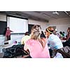 College students sitting in a classroom during class (shallow DOF; color toned image)