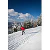 Cross-country skiing: young man cross-country skiing on a lovely sunny winter day