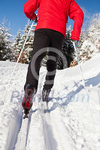Cross-country skiing: young man cross-country skiing on a lovely sunny winter day Cross-country skiing: young man cross-country skiing on a lovely sunny winter day