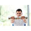 young man in fintess sport club exercise with weights and relaxing