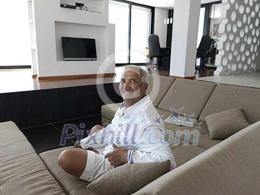 Portrait of senior man relaxing in sofa at home Portrait of senior man relaxing in sofa at home