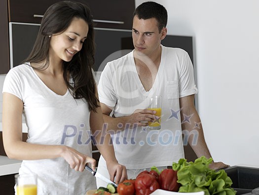 happy young couple have fun in modern kitchen indoor while preparing fresh fruits and vegetables food salad happy young couple have fun in modern kitchen indoor while preparing fresh fruits and vegetables food salad
