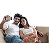 cheerful happy young couple making selfie together at home