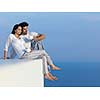 happy young romantic couple have fun relax smile at modern home outdoor terace balcony terace
