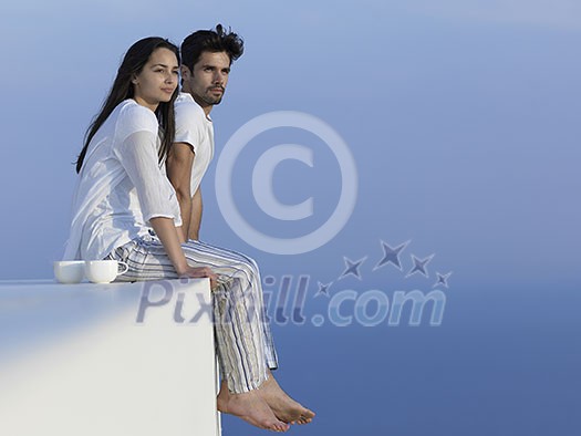 happy young romantic couple have fun relax smile at modern home outdoor terace balcony terace