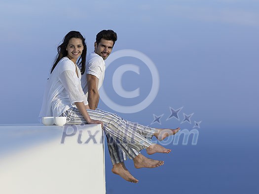 happy young romantic couple have fun relax smile at modern home outdoor terace balcony terace