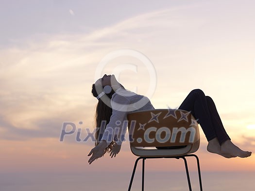 happy young woman enjoy sunset while dancing and enjoy music on headphones happy young woman enjoy sunset while dancing and enjoy music on headphones