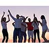 group of happy young people dancing and have fun on party in modern home bacony with sunset and ocean in background
