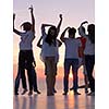 group of happy young people dancing and have fun on party in modern home bacony with sunset and ocean in background