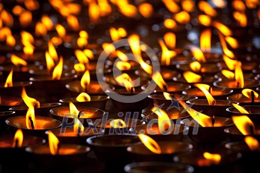 Burning candles in Buddhist temple. Tsuglagkhang complex, McLeod Ganj, Himachal Pradesh, India Burning candles in Buddhist temple. Tsuglagkhang complex, McLeod Ganj, Himachal Pradesh, India