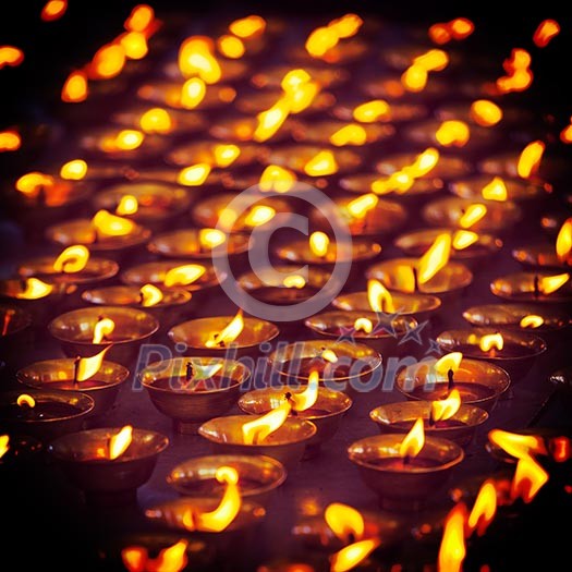 Vintage retro effect filtered hipster style travel image of burning candles in Buddhist temple. Tsuglagkhang complex, McLeod Ganj, Himachal Pradesh, India Vintage retro effect filtered hipster style travel image of burning candles in Buddhist temple. Tsuglagkhang complex, McLeod Ganj, Himachal Pradesh, India